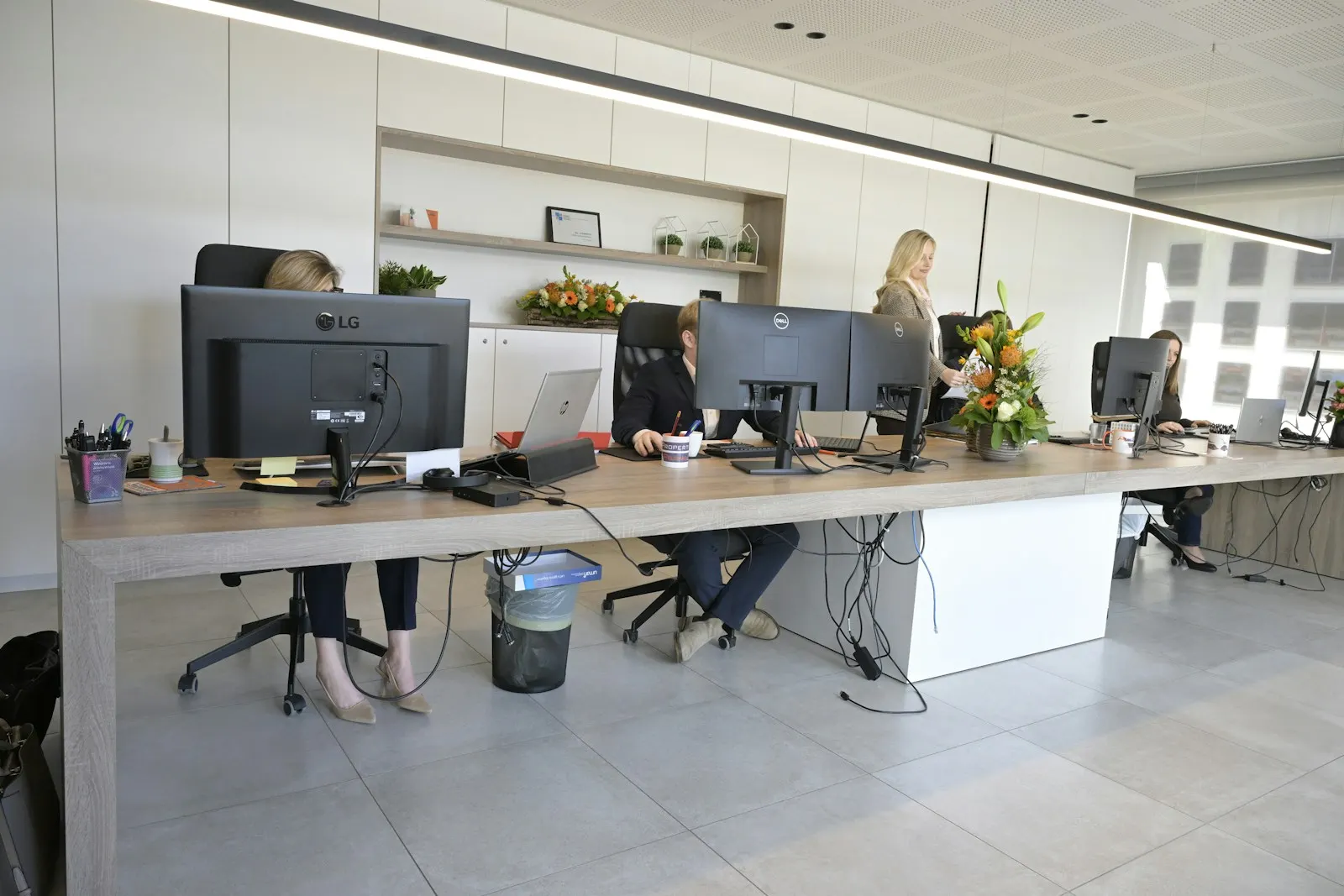 People working at desks in a modern open-plan office