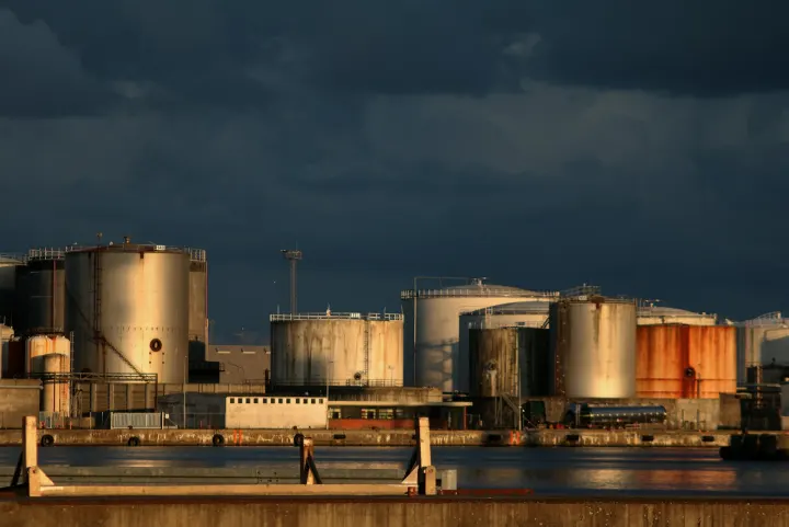 A large industrial area with a body of water in front of it
