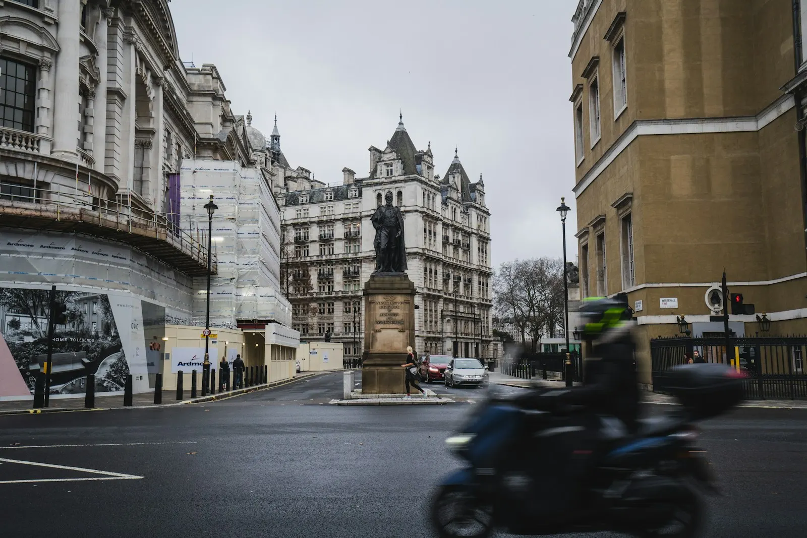 A motorcyclist rides down a city street