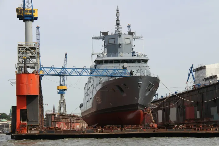 Red and white ship on dock during daytime