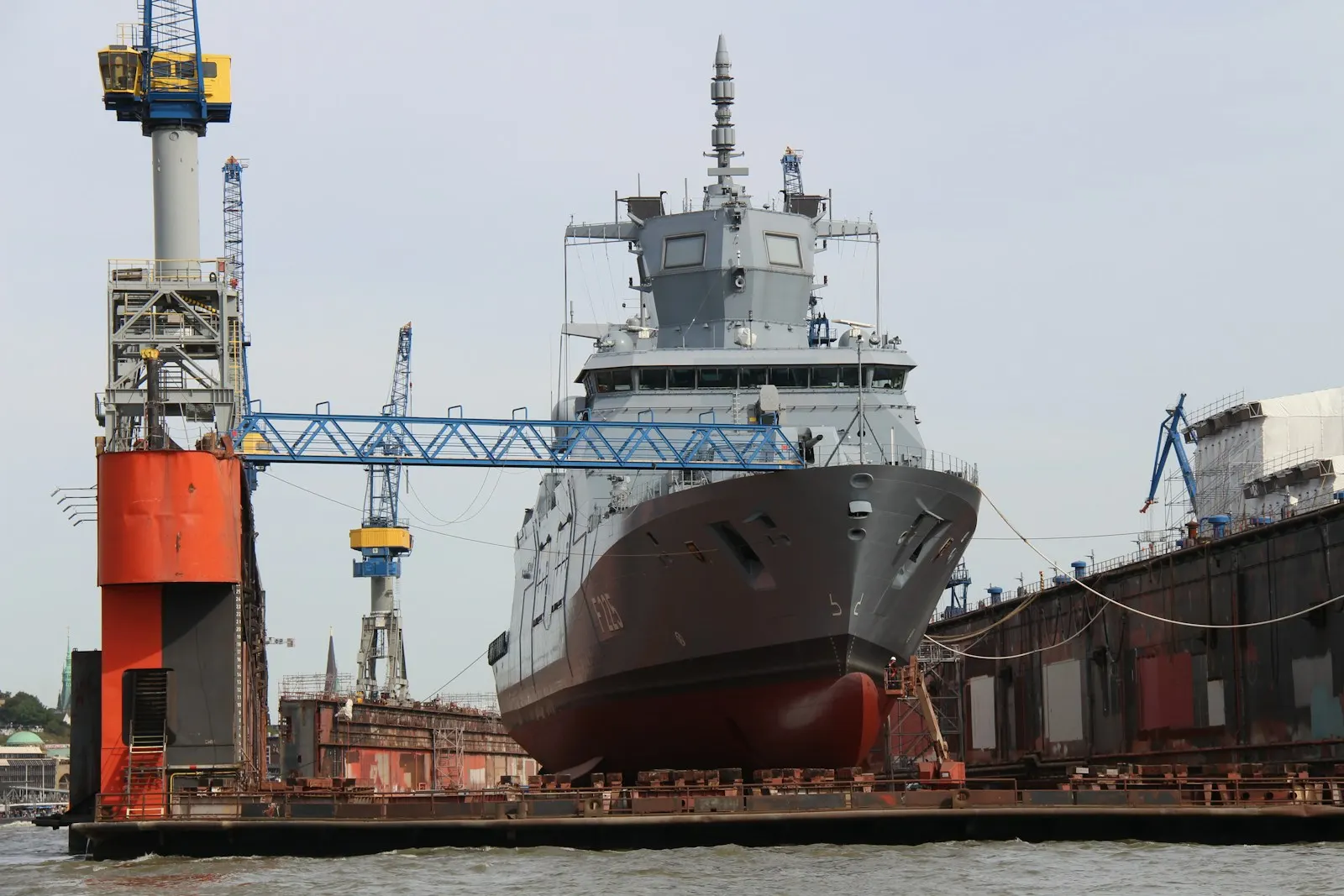 Red and white ship on dock during daytime