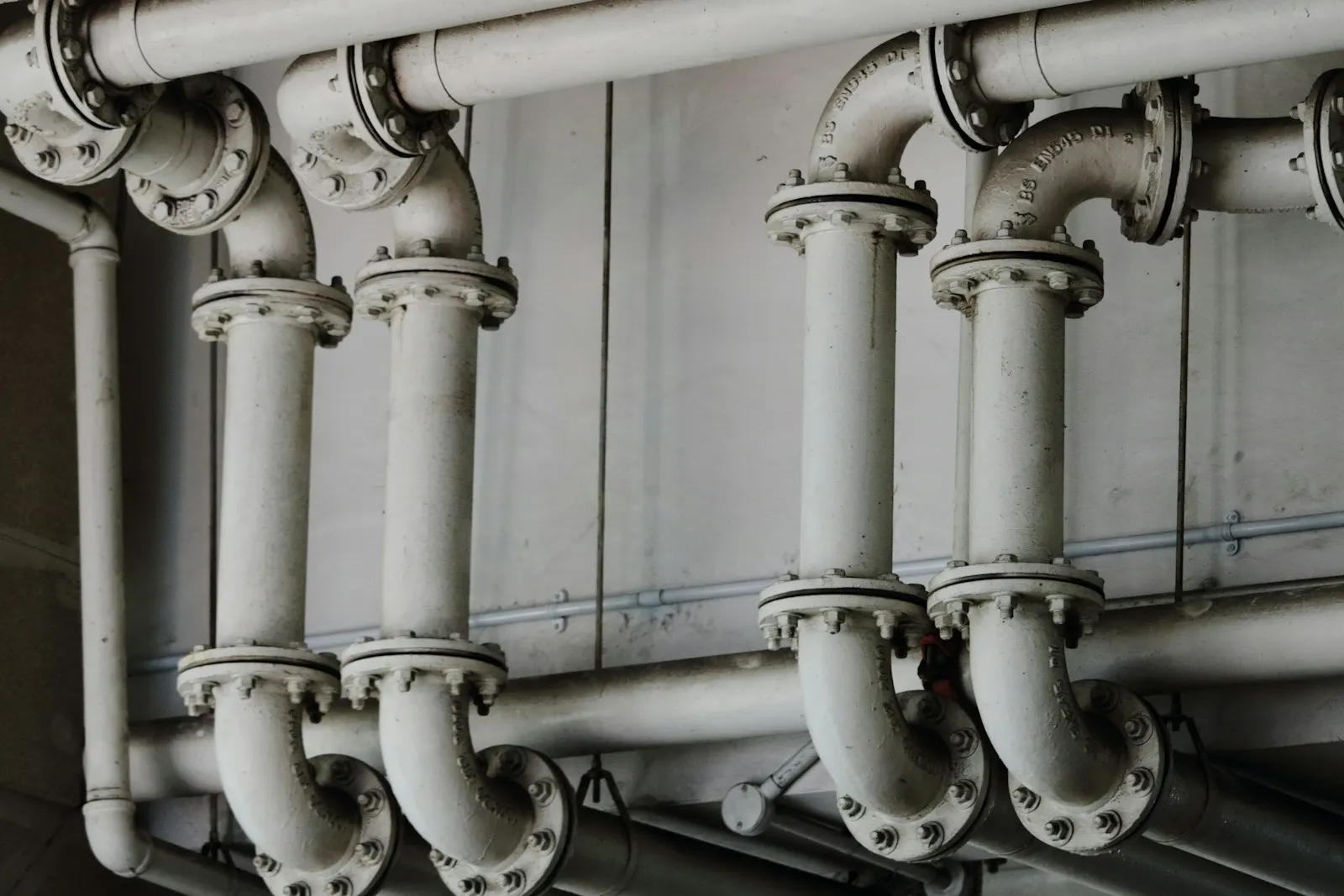 Grayscale photography of metal pipes