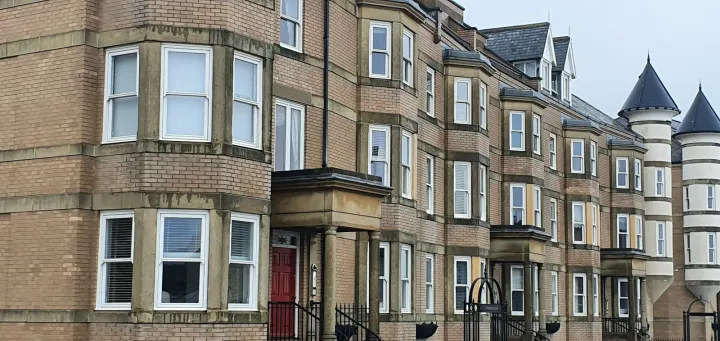 A row of brick buildings with a red door