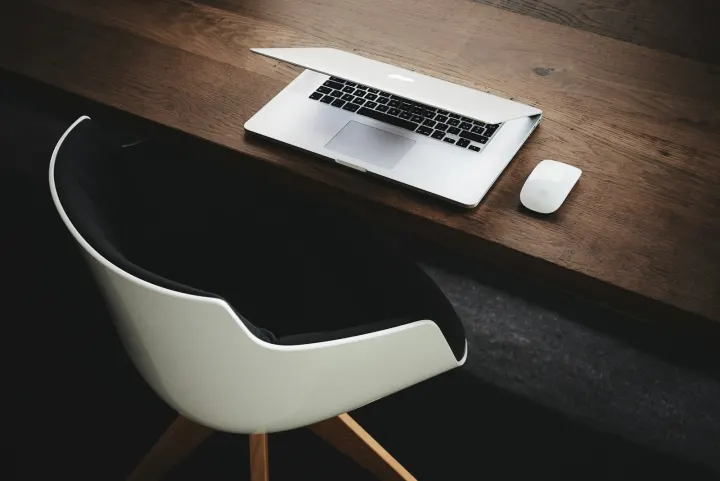 Apple macbook beside computer mouse on table