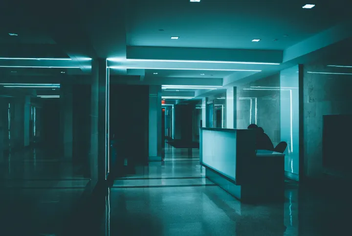 White wooden desk on hallway inside building